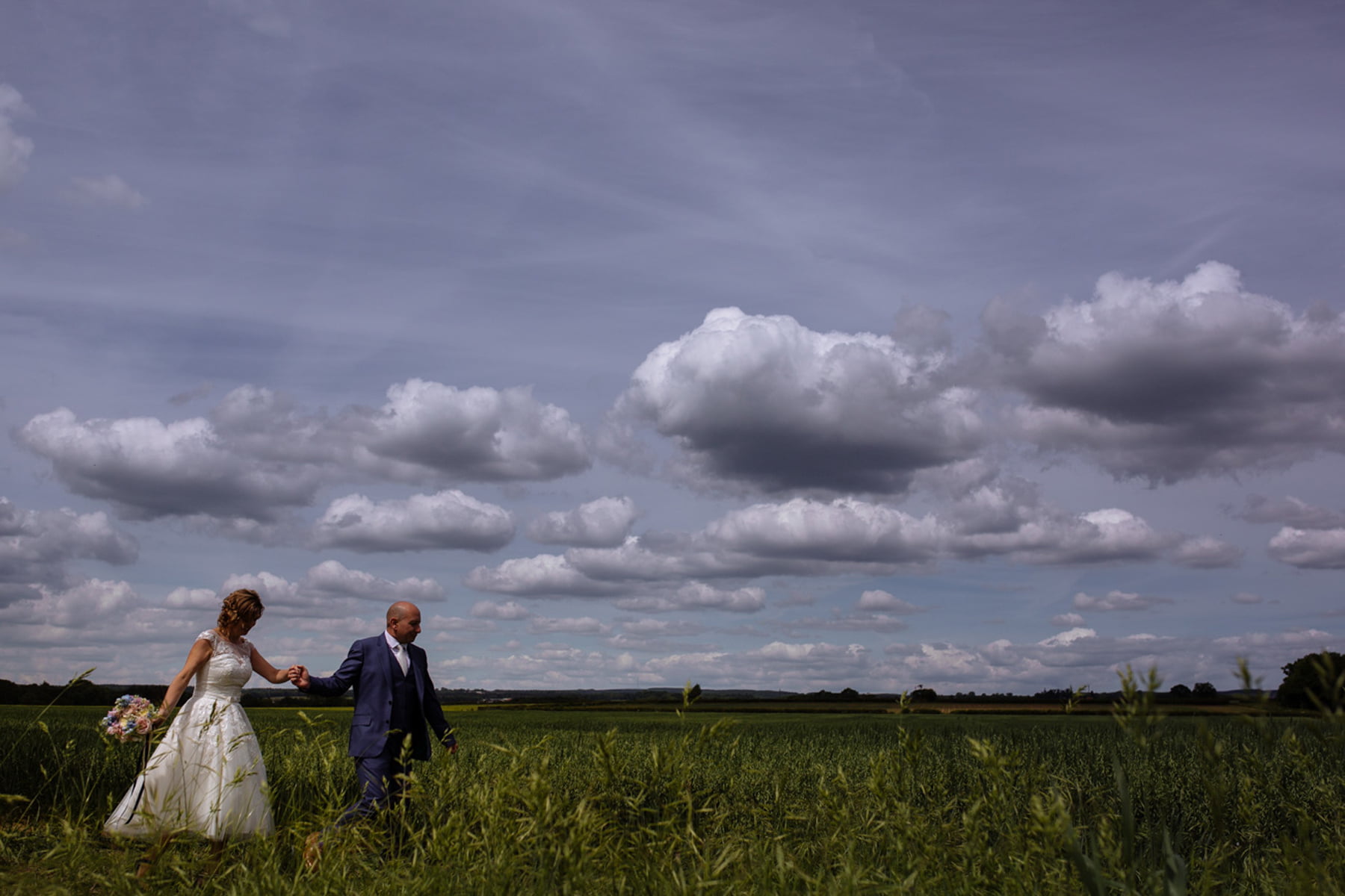 bride and groom in field at star inn harome york wedding photographer