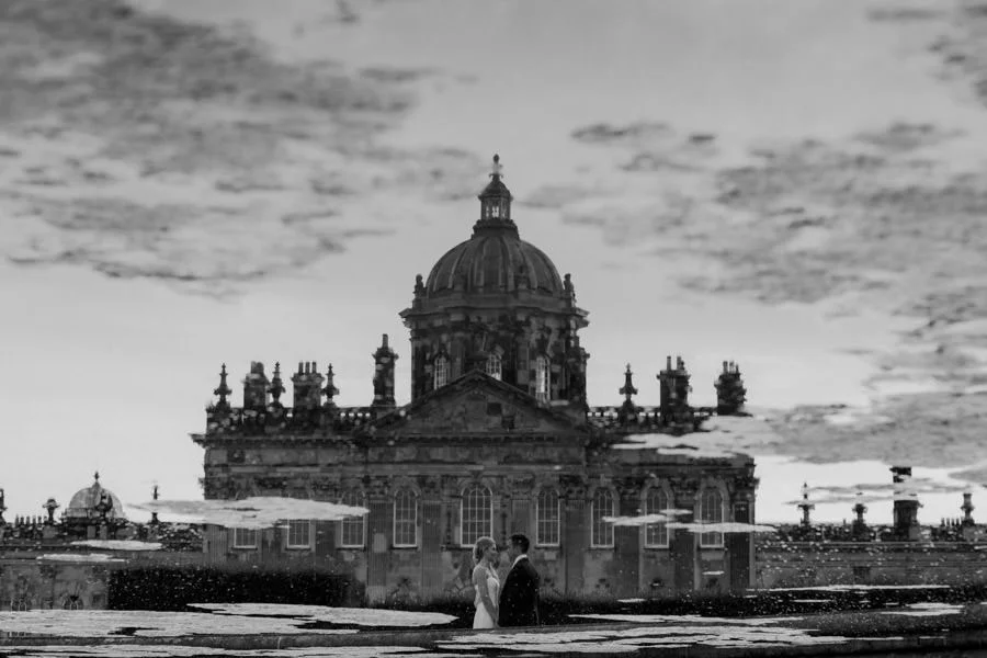 Bride and groom reflection of Castle Howard in fountain. Creativ bride and groom reflection of castle howard in fountain creative photographer