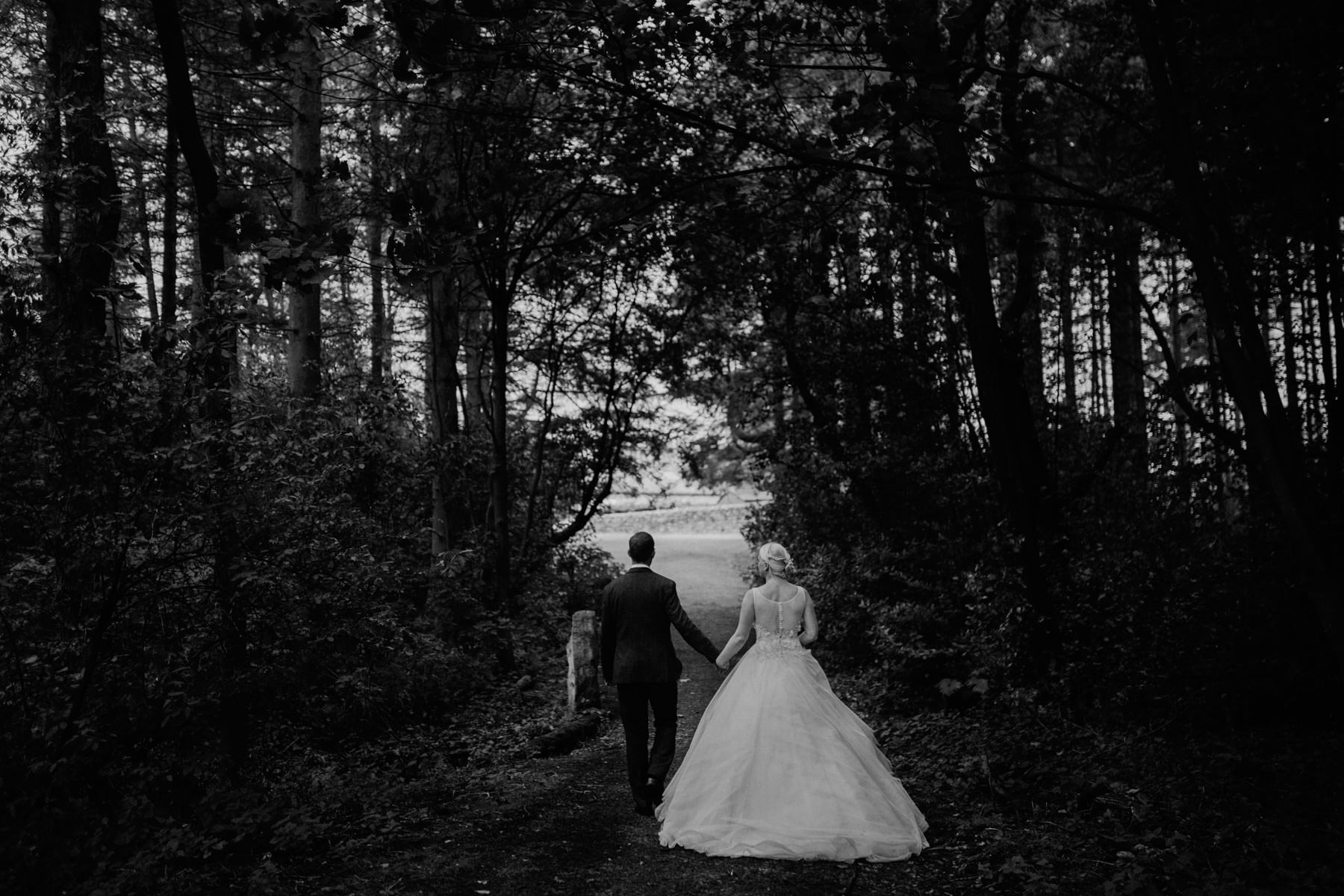 bride and groom in woodland lineham farm wedding photographer