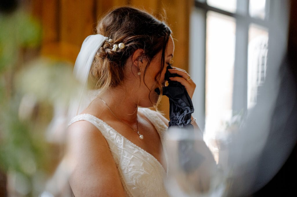 bride wiping tears at lodge farm wedding venue cundall