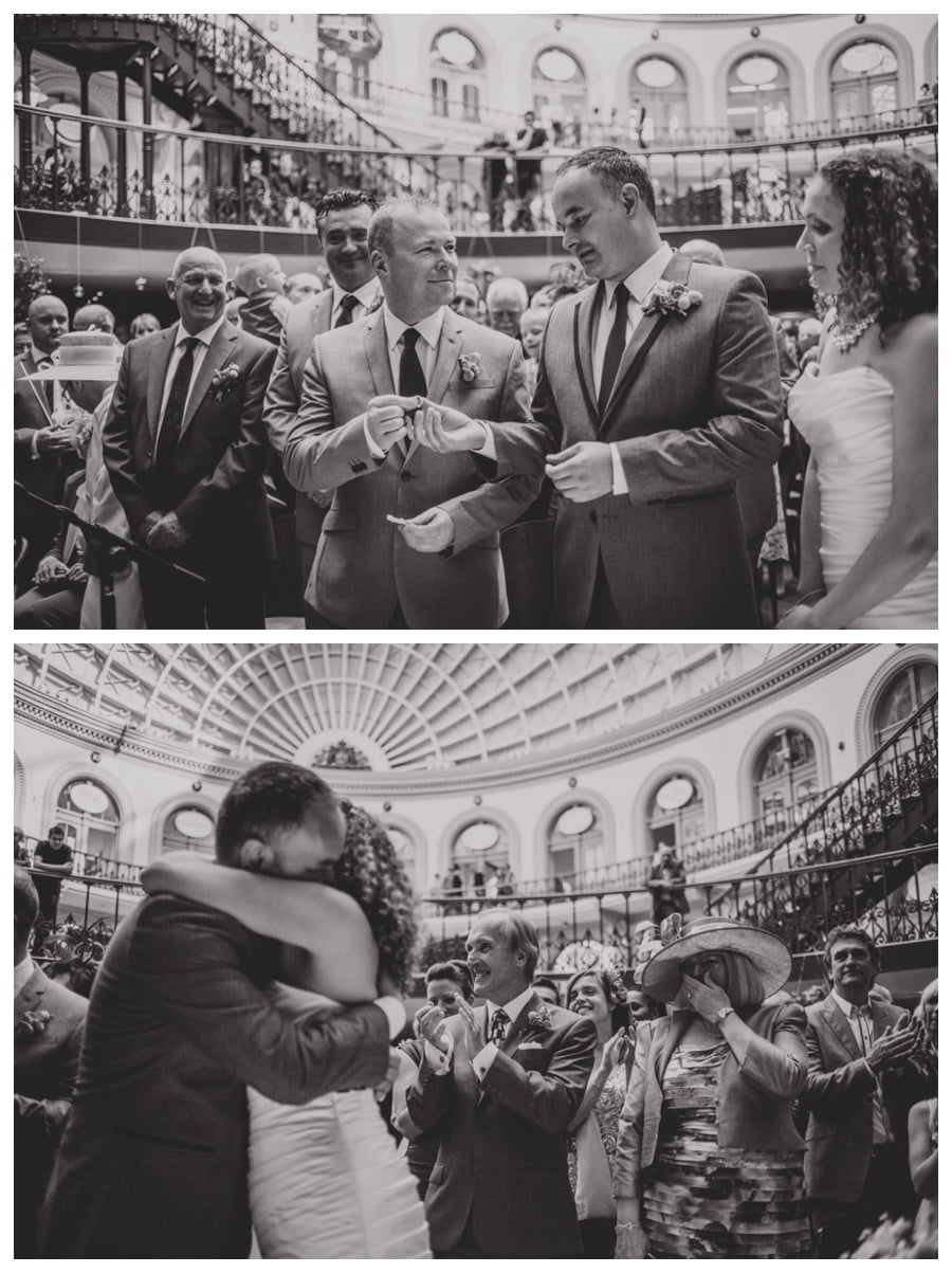 Bride & groom exchanging rings at Leeds Corn Exchange
