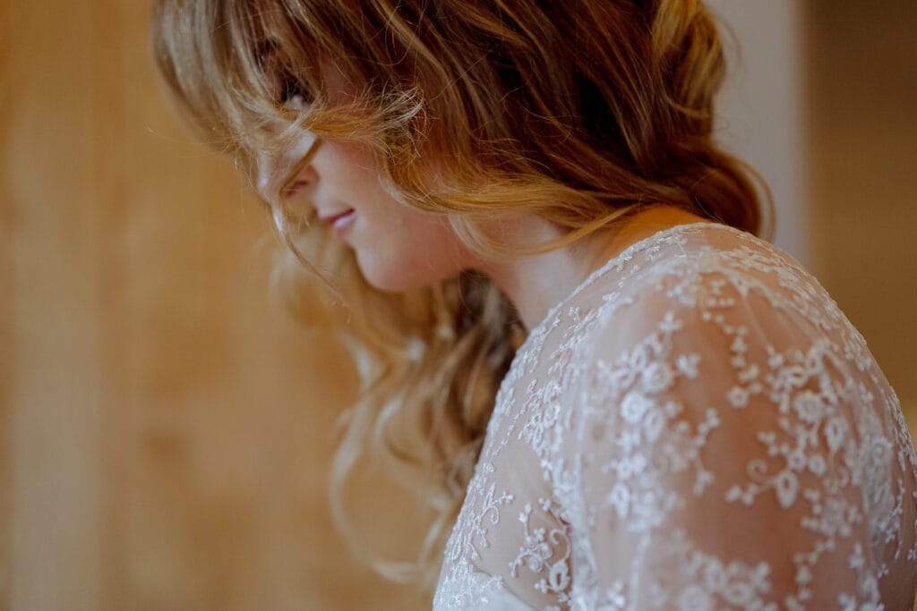 bride putting on gown at lodge farm
