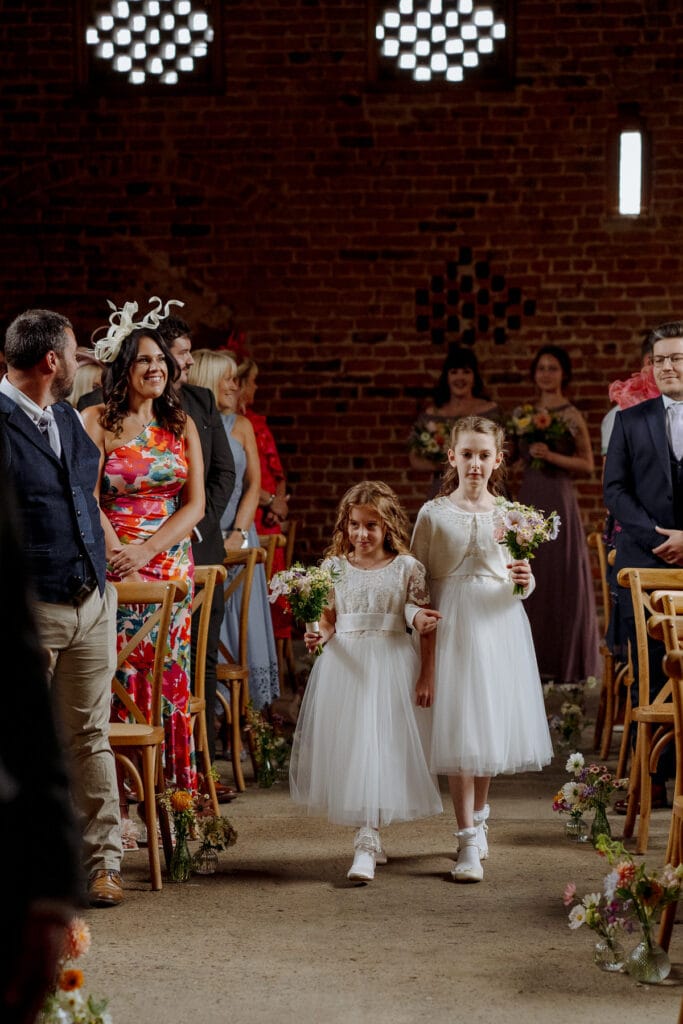flower girls walking down aisle at lodge farm wedding venue cundall