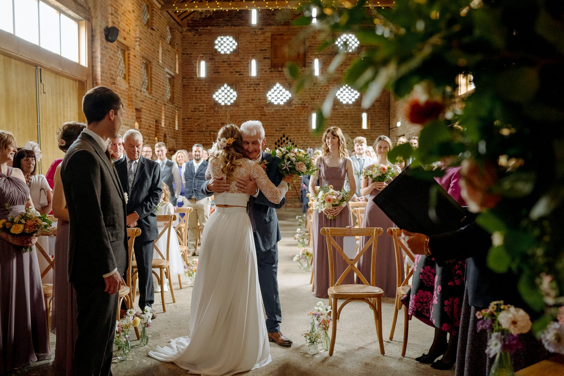 father hugs bride at lodge farm wedding venue cundall
