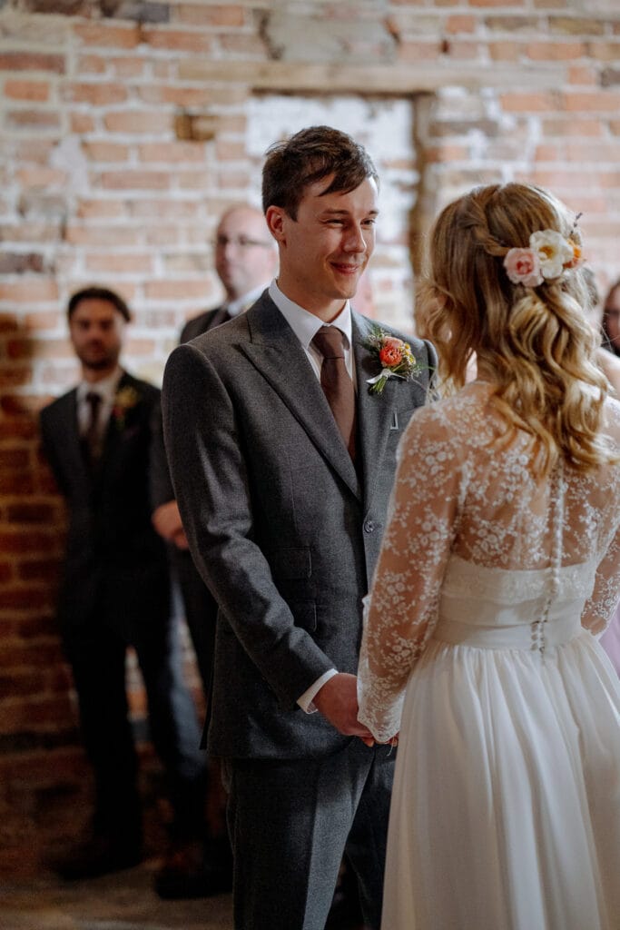 bride and groom exchange vows at lodge farm wedding venue cundall