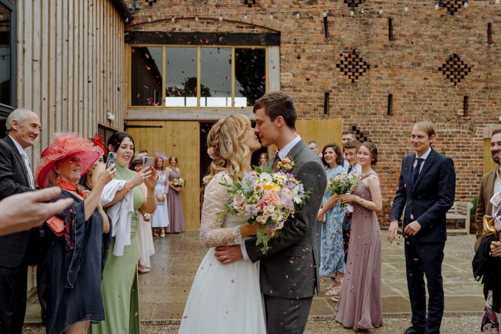 bride and groom kissing at lodge farm wedding venue cundall