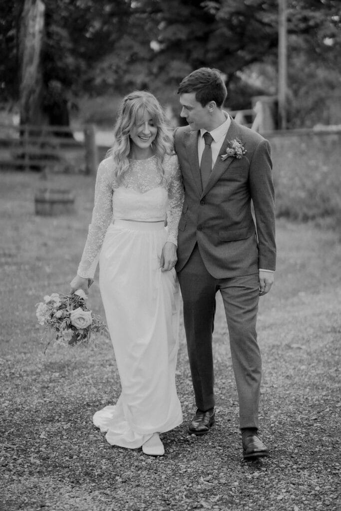 Bride and groom walking at Lodge farm wedding barn