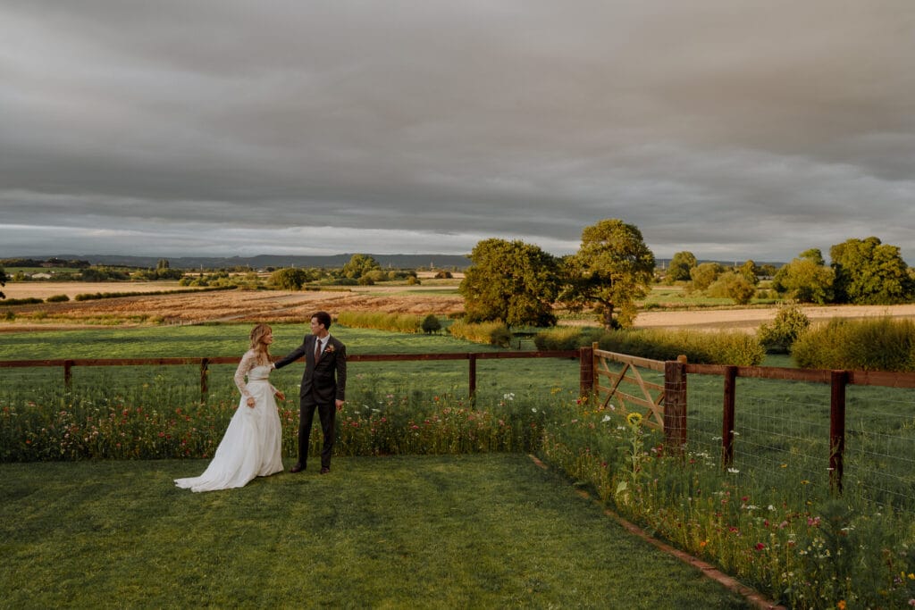 bride and groom in landscape at Lodge farm wedding venue